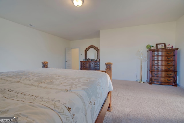 carpeted bedroom featuring visible vents