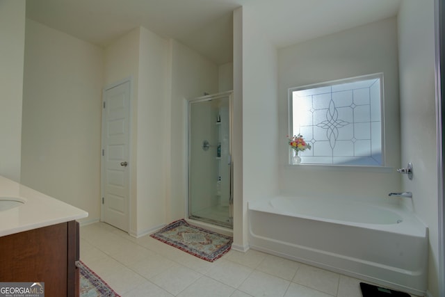 bathroom with vanity, a shower stall, a bath, and tile patterned floors