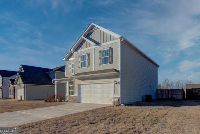 craftsman-style home featuring brick siding, concrete driveway, an attached garage, board and batten siding, and fence