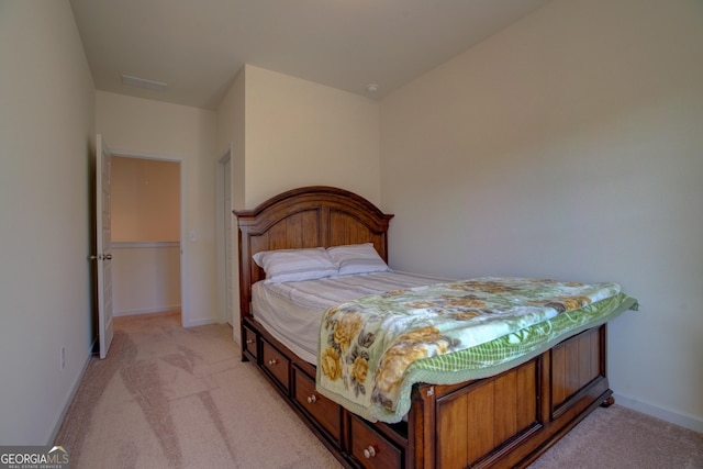 bedroom with light carpet and baseboards