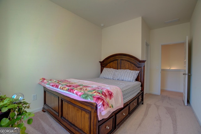 bedroom featuring light carpet and baseboards