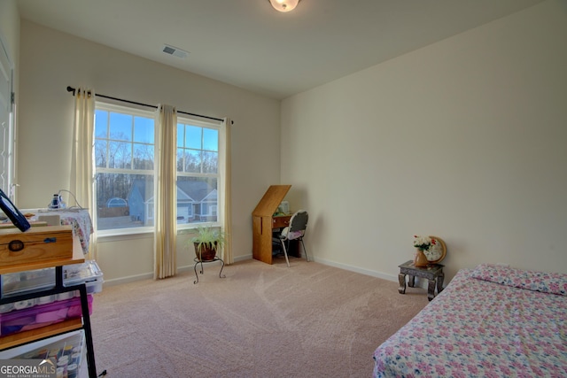 carpeted bedroom with visible vents and baseboards