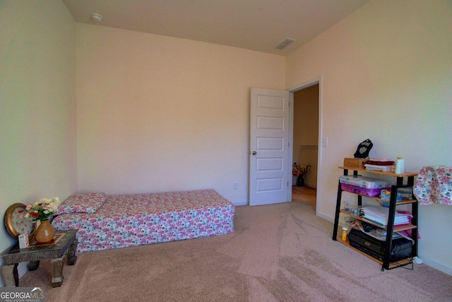 carpeted bedroom with visible vents and baseboards