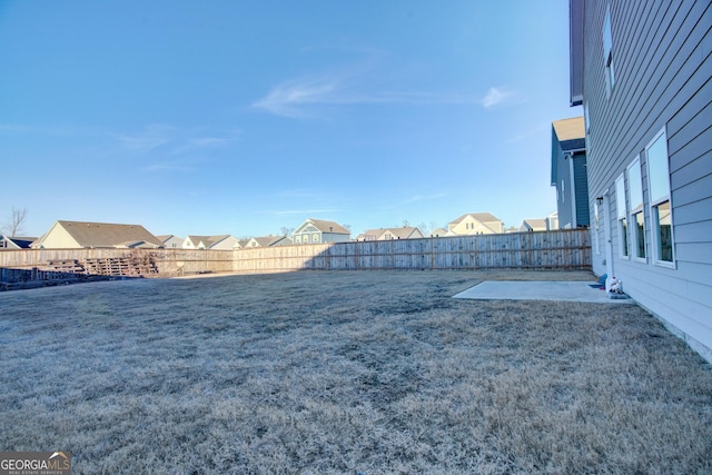 view of yard featuring a patio area and a fenced backyard