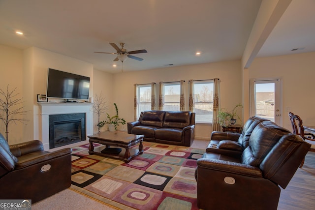 living area with visible vents, a premium fireplace, a ceiling fan, and recessed lighting