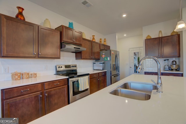 kitchen featuring stainless steel appliances, light countertops, visible vents, a sink, and under cabinet range hood