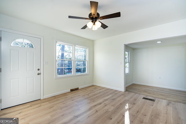 entrance foyer featuring light wood-style floors, baseboards, visible vents, and a wealth of natural light