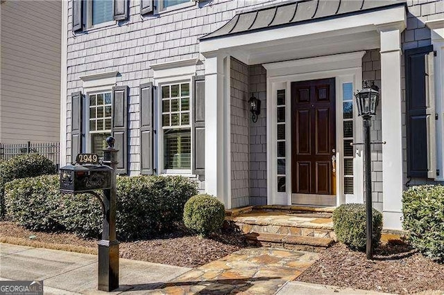 doorway to property featuring a standing seam roof and metal roof