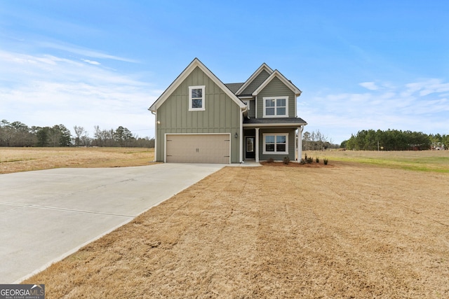 craftsman-style house featuring board and batten siding, a front yard, driveway, and a garage