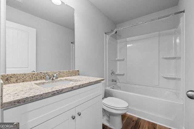 full bath featuring shower / bathing tub combination, vanity, toilet, and wood finished floors