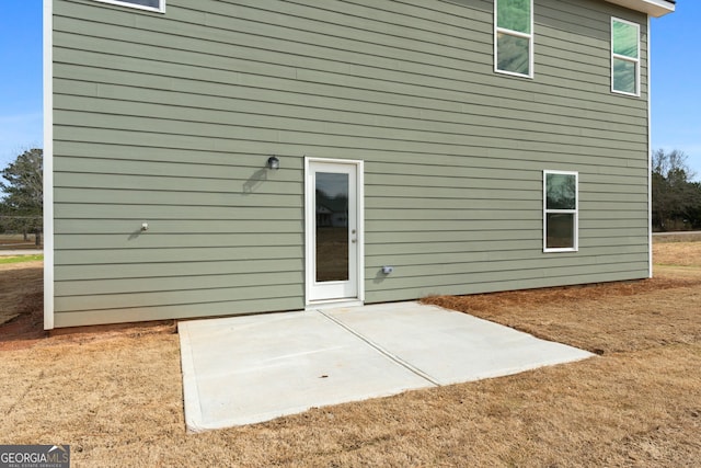 rear view of property featuring a patio area