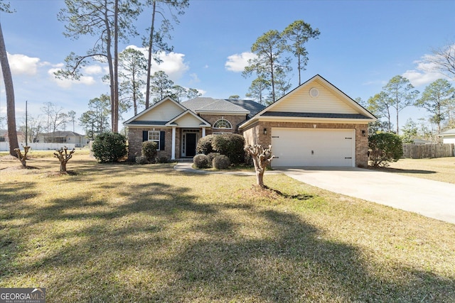 view of front of property with an attached garage, driveway, brick siding, and a front yard