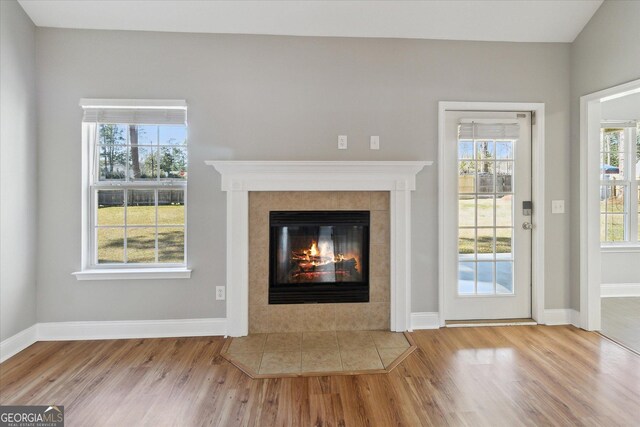 unfurnished living room with plenty of natural light and wood finished floors