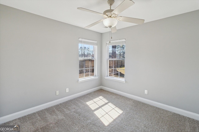 empty room featuring ceiling fan, carpet flooring, and baseboards