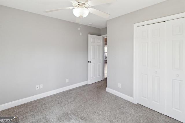 unfurnished bedroom with carpet floors, a closet, ceiling fan, and baseboards