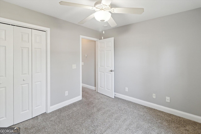 unfurnished bedroom featuring carpet floors, ceiling fan, baseboards, and a closet