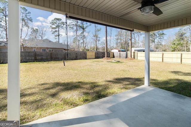 view of yard featuring a patio, a fenced backyard, and a ceiling fan