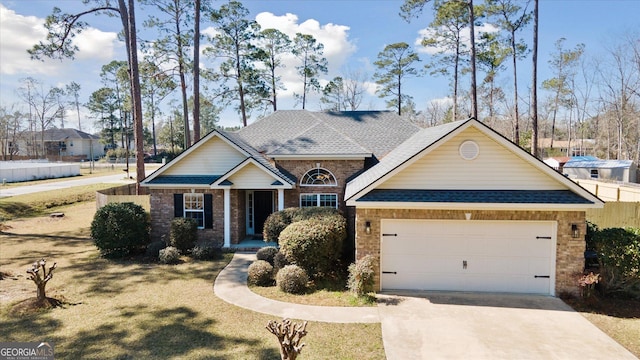 craftsman inspired home with a garage, a shingled roof, concrete driveway, and brick siding