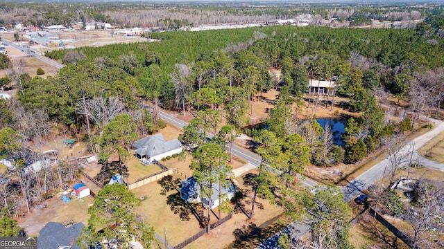 drone / aerial view featuring a wooded view
