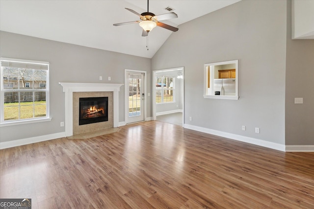 unfurnished living room with ceiling fan, plenty of natural light, and wood finished floors