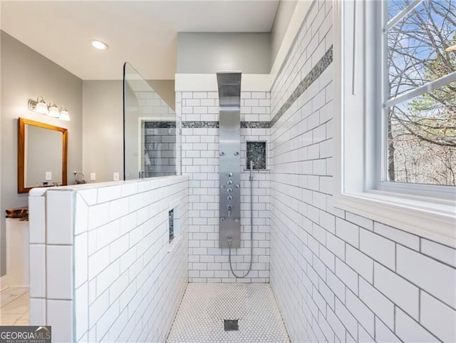 bathroom with tiled shower and recessed lighting