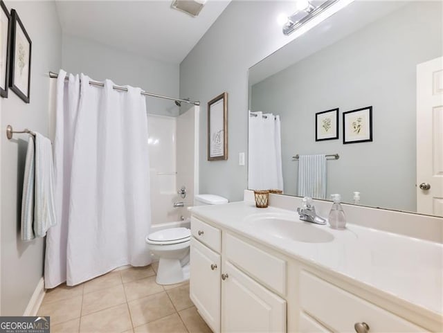 full bathroom featuring toilet, vanity, shower / bath combo with shower curtain, and tile patterned floors