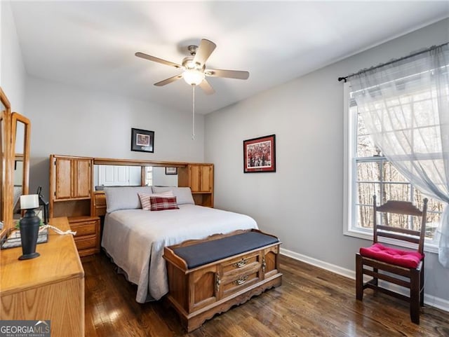 bedroom with a ceiling fan, dark wood-style flooring, and baseboards