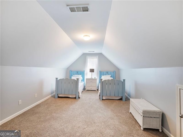 bedroom with vaulted ceiling, carpet floors, visible vents, and baseboards