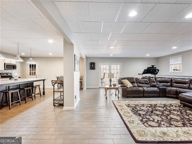 living room with recessed lighting, plenty of natural light, and baseboards