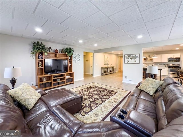 living room with baseboards, wood finished floors, and recessed lighting