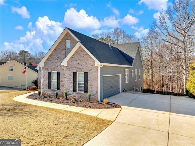 view of front facade with a garage, driveway, and brick siding