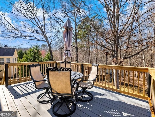 wooden terrace featuring outdoor dining area