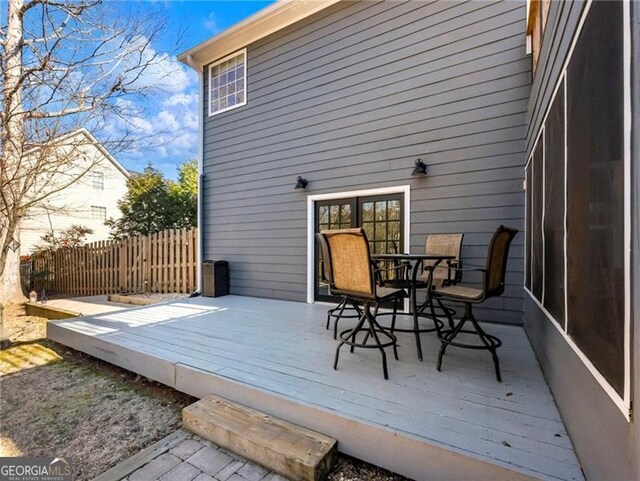 deck featuring outdoor dining space and fence