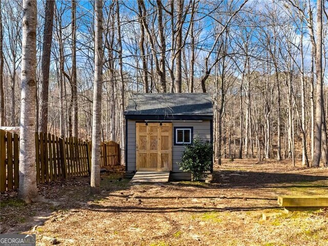 view of shed with fence