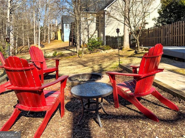 view of patio / terrace with an outdoor fire pit and fence