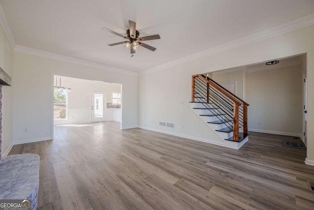 3800 George Williams Rd, Monroe, GA 30656 - unfurnished living room with crown molding, visible vents, wood finished floors, baseboards, and stairs