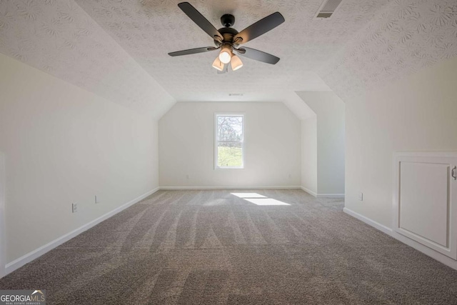 3800 George Williams Rd, Monroe, GA 30656 - bonus room with a textured ceiling, lofted ceiling, light carpet, visible vents, and baseboards