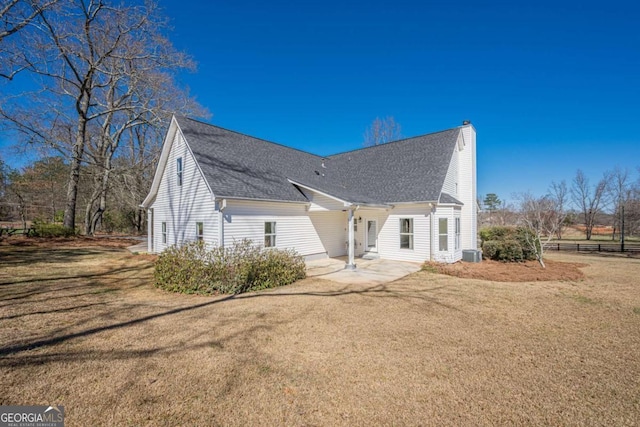 3800 George Williams Rd, Monroe, GA 30656 - view of side of property featuring roof with shingles, a yard, a chimney, and fence
