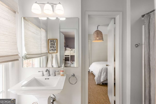 bathroom with a sink and ensuite bath