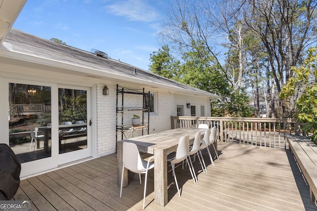 deck featuring outdoor dining area