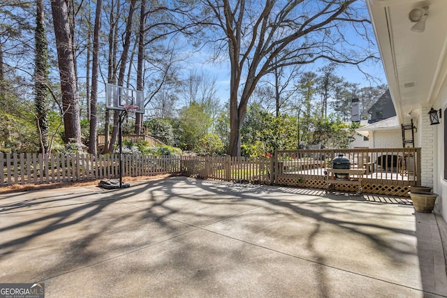 view of patio featuring fence and a deck