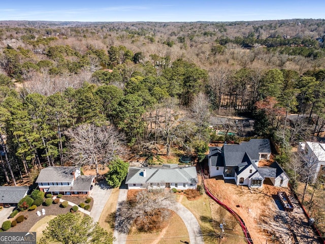 drone / aerial view featuring a forest view