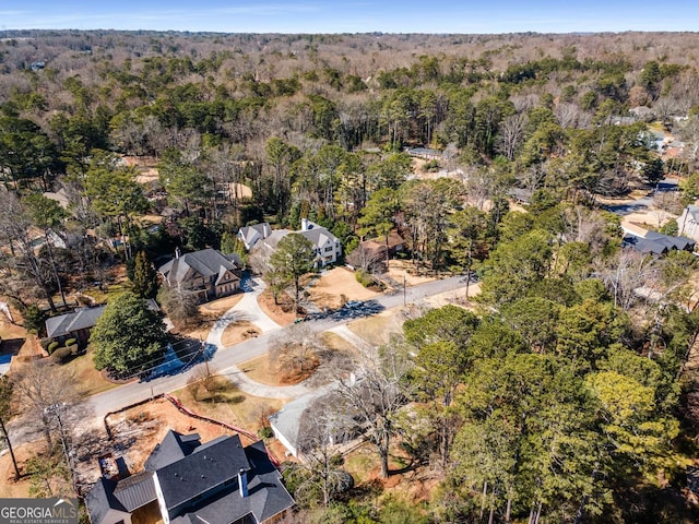 birds eye view of property featuring a forest view