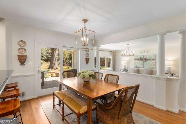 dining space featuring ornate columns, visible vents, ornamental molding, and light wood finished floors