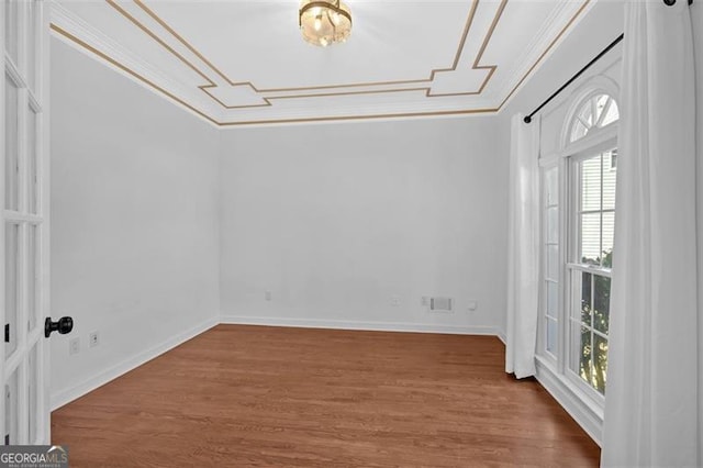 unfurnished dining area featuring baseboards, ornamental molding, and wood finished floors