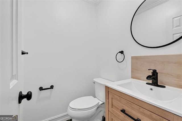 half bathroom with toilet and vanity
