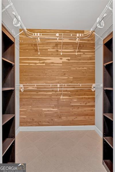 walk in closet with tile patterned floors