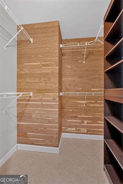 walk in closet with tile patterned floors