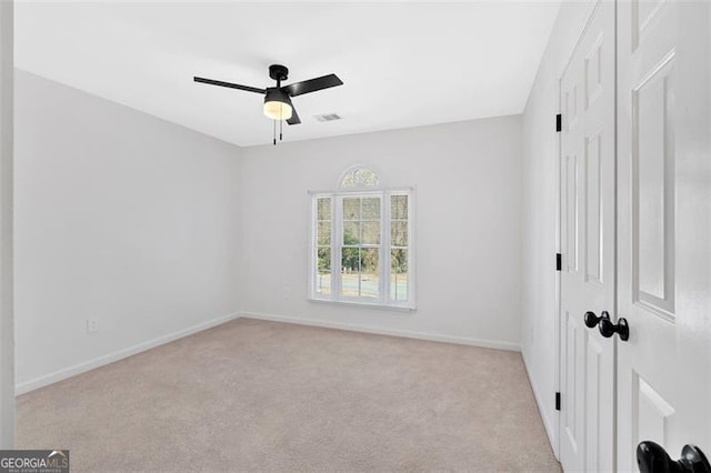 unfurnished bedroom featuring carpet floors, baseboards, visible vents, and ceiling fan