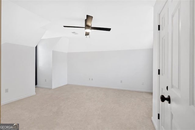 bonus room with baseboards, vaulted ceiling, a ceiling fan, and light colored carpet